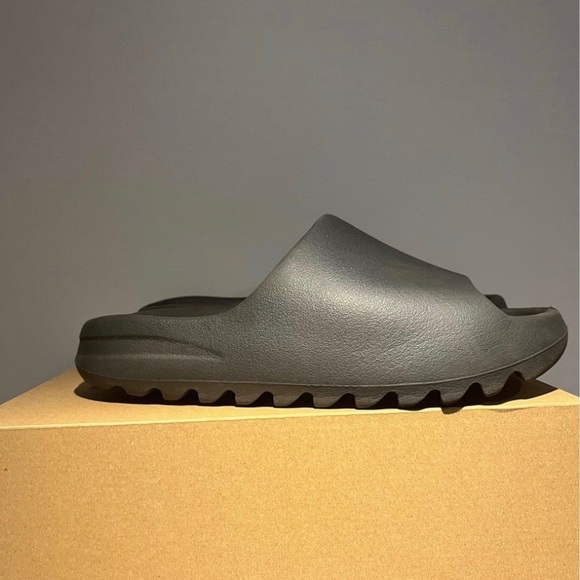 black yeezy slides on feet